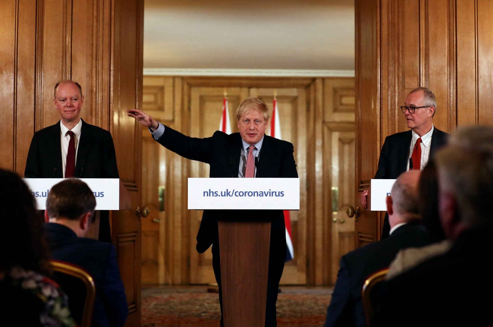 British Prime Minister Boris Johnson, Chief Medical Officer for England, Chris Whitty and Government Chief Scientific Adviser, Sir Patrick Vallance attend a news conference addressing the government's response to the coronavirus outbreak, at Downing Street in London, Britain March 12, 2020. (Reuters Photo)