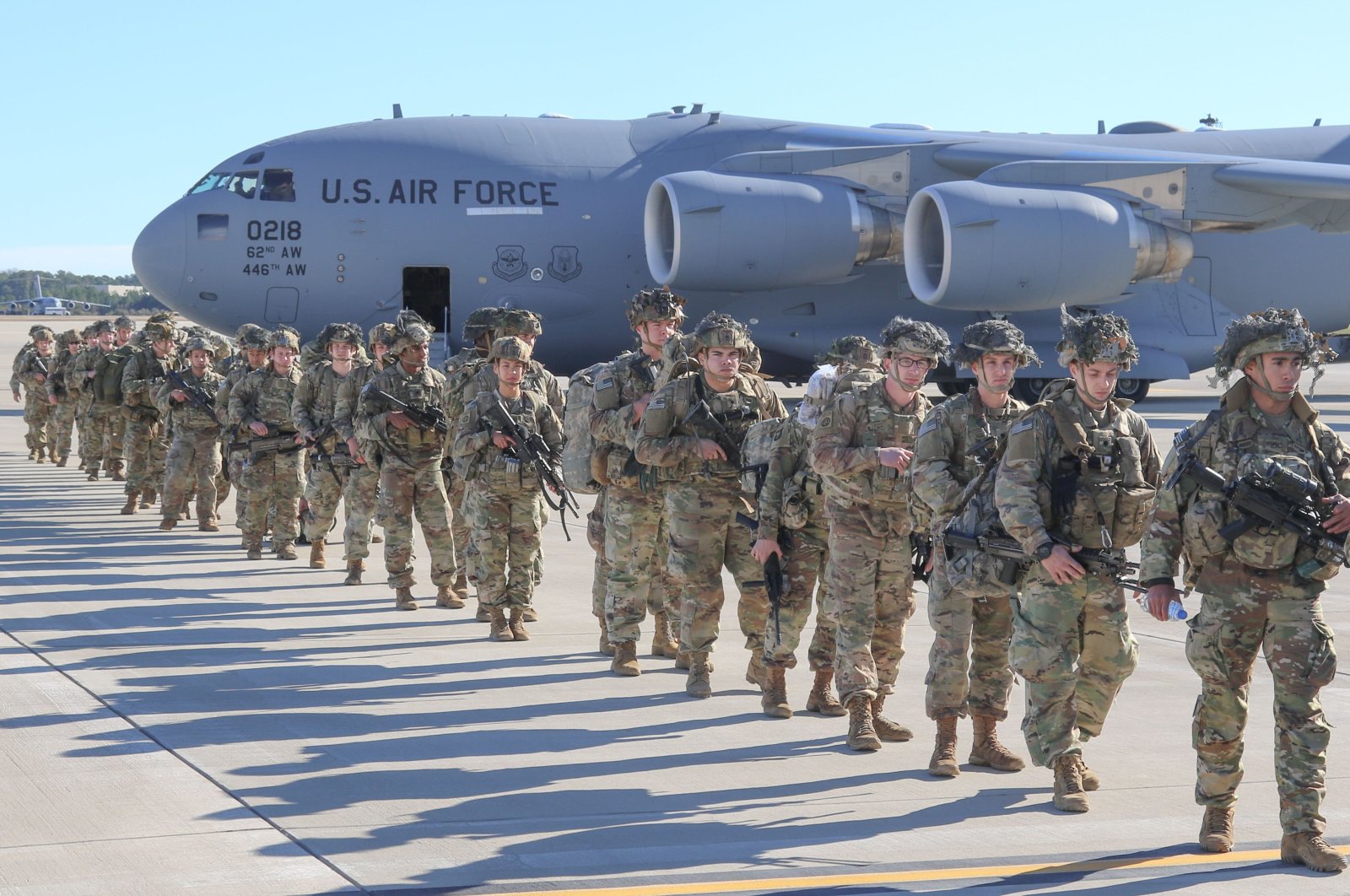 This handout picture released by the US Army shows U.S. Army Paratroopers assigned to the 2nd Battalion, 504th Parachute Infantry Regiment, 1st Brigade Combat Team, 82nd Airborne Division, deploy from Pope Army Airfield, North Carolina on January 1, 2020. (AFP Photo)