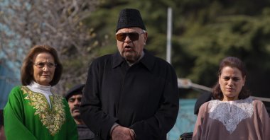 Former Chief Minister of Jammu and Kashmir and National Conference party president Farooq Abdullah,(C) flanked by his wife Molly Abdullah, (L) and daughter Safia Abdullah speaks to media persons at his residence, Srinagar, March 13, 2020. (AP Photo)
