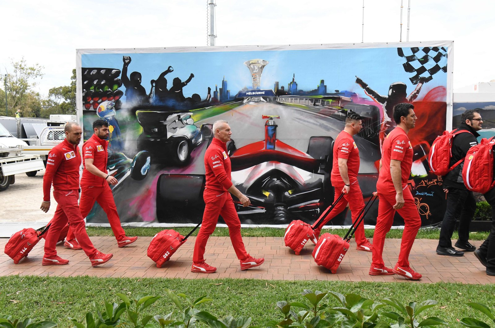 Members of the Ferrari team arrive to pack up their equipment after the Australian Grand Prix was canceled, Melbourne, March 13, 2020. (AFP Photo)