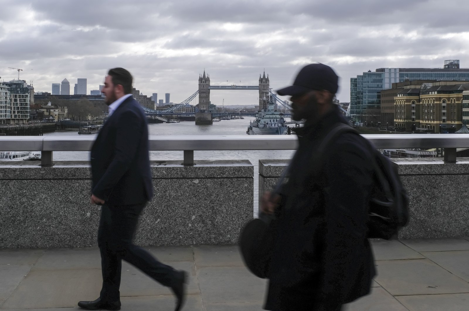 People commute across London Bridge, London, March 13, 2020. (AP Photo)