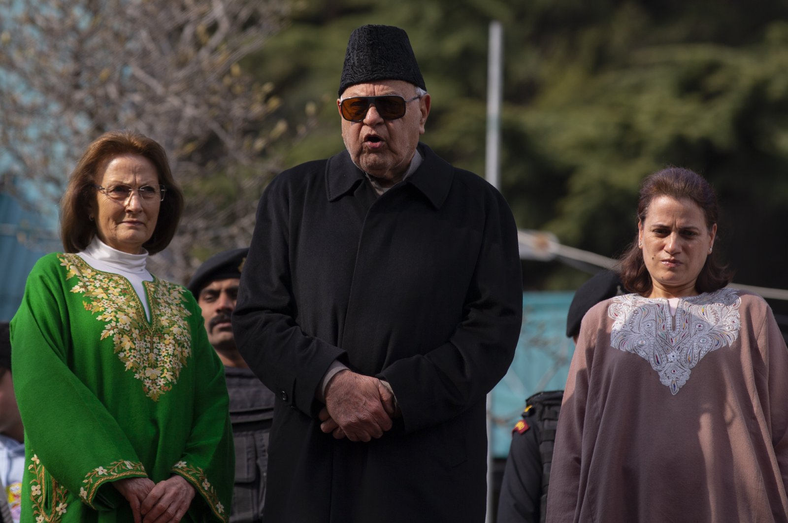 Former Chief Minister of Jammu and Kashmir and National Conference party president Farooq Abdullah,(C) flanked by his wife Molly Abdullah, (L) and daughter Safia Abdullah speaks to media persons at his residence, Srinagar, March 13, 2020. (AP Photo)