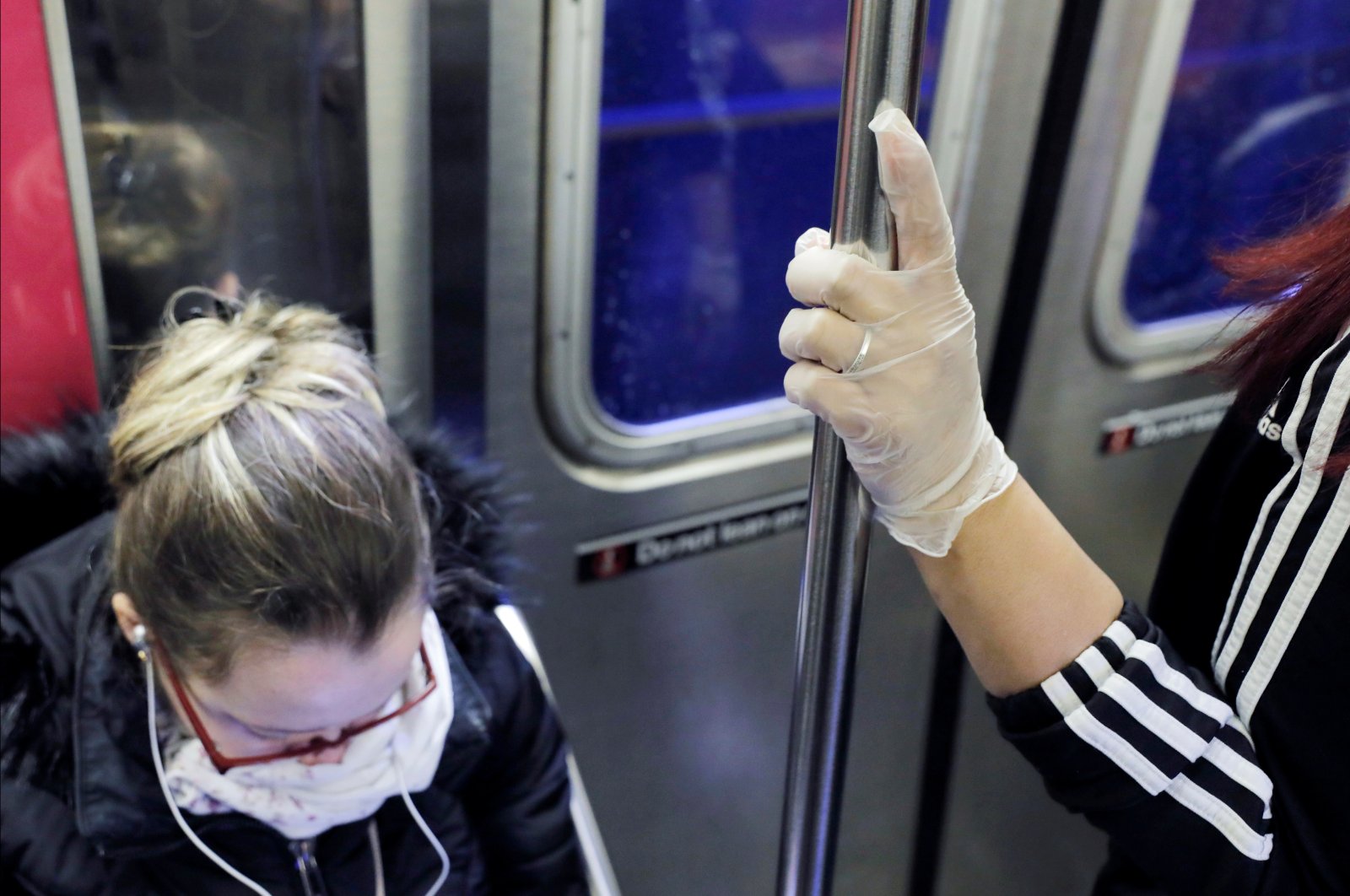 Commuters shield themselves on a peak hour subway as the coronavirus outbreak continued in Manhattan, New York City, New York, U.S., March 13. (Reuters Photo) 