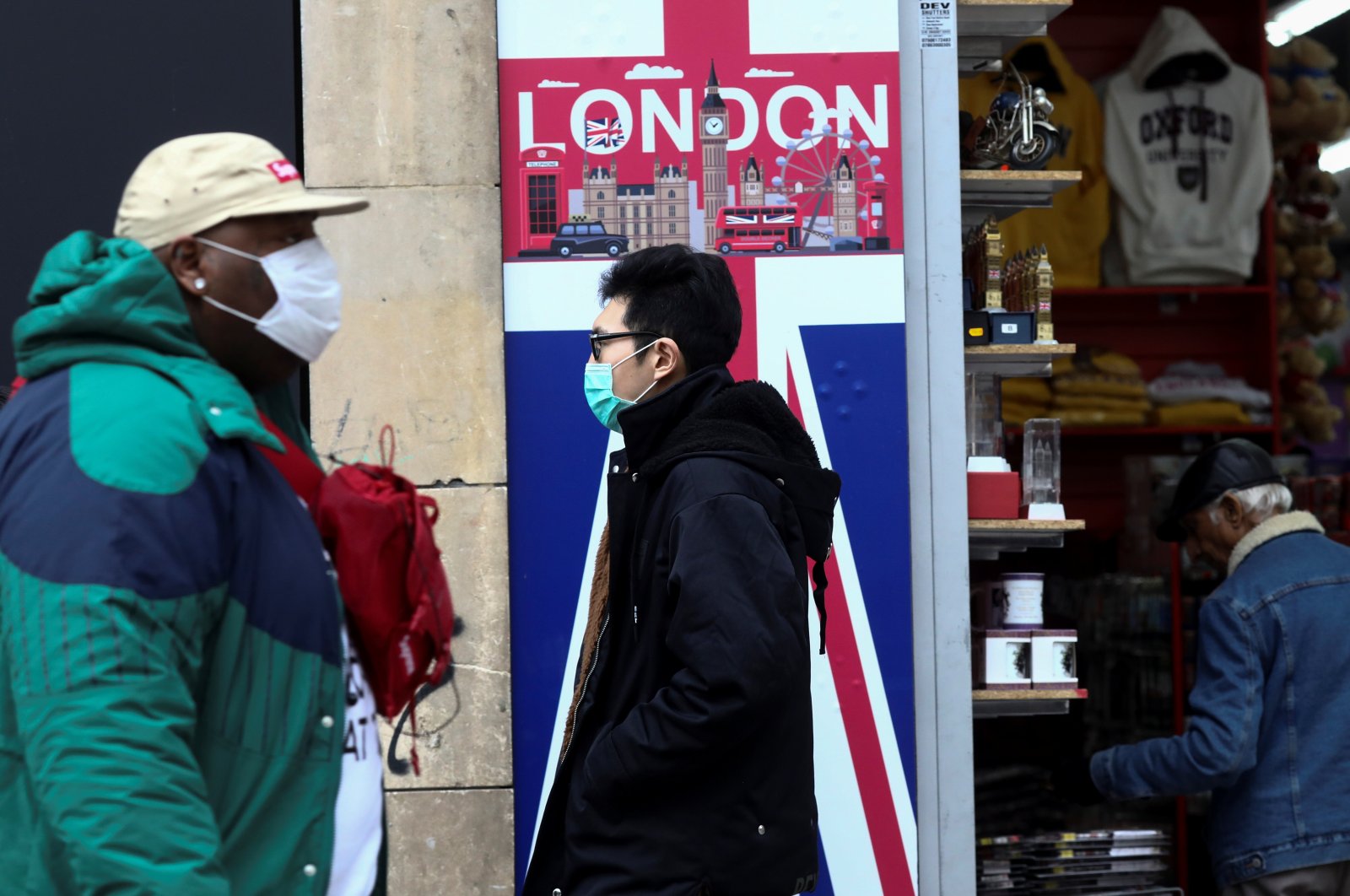 People wearing protective masks walk past a souvenir store on Oxford Street in London, Britain March 14. (Reuters Photo)