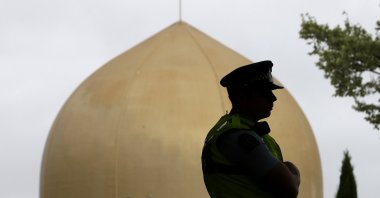 A police officer stands in a park near the Al Noor mosque in Christchurch, New Zealand, Sunday, March 15, 2020. A national memorial in New Zealand to commemorate the 51 people who were killed when a gunman attacked two mosques one year ago has been canceled due to fears over the new coronavirus. (AP Photo)