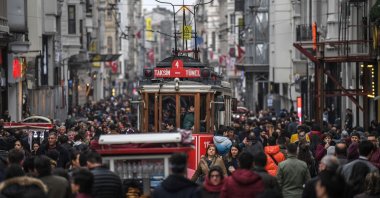A nostalgic tram drives through a crowd in İstiklal Avenue in Taksim, Istanbul, Jan. 25, 2019. (AFP Photo) 