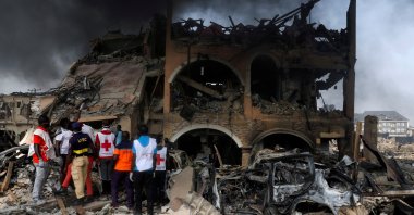 Paramedics and security men observe a building that was damaged by the pipeline explosion at Abule Ado in Lagos, Nigeria, March 15, 2020. (Reuters Photo)