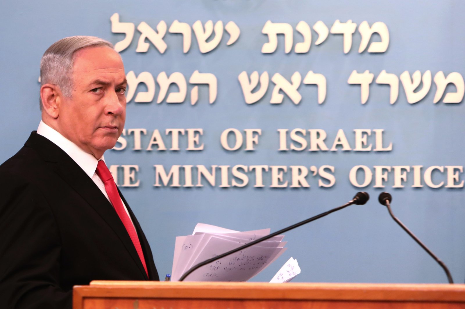 Israeli Prime Minister Benjamin Netanyahu approaches the podium to give a speech from his Jerusalem office, March 14, 2020. (AP Photo)