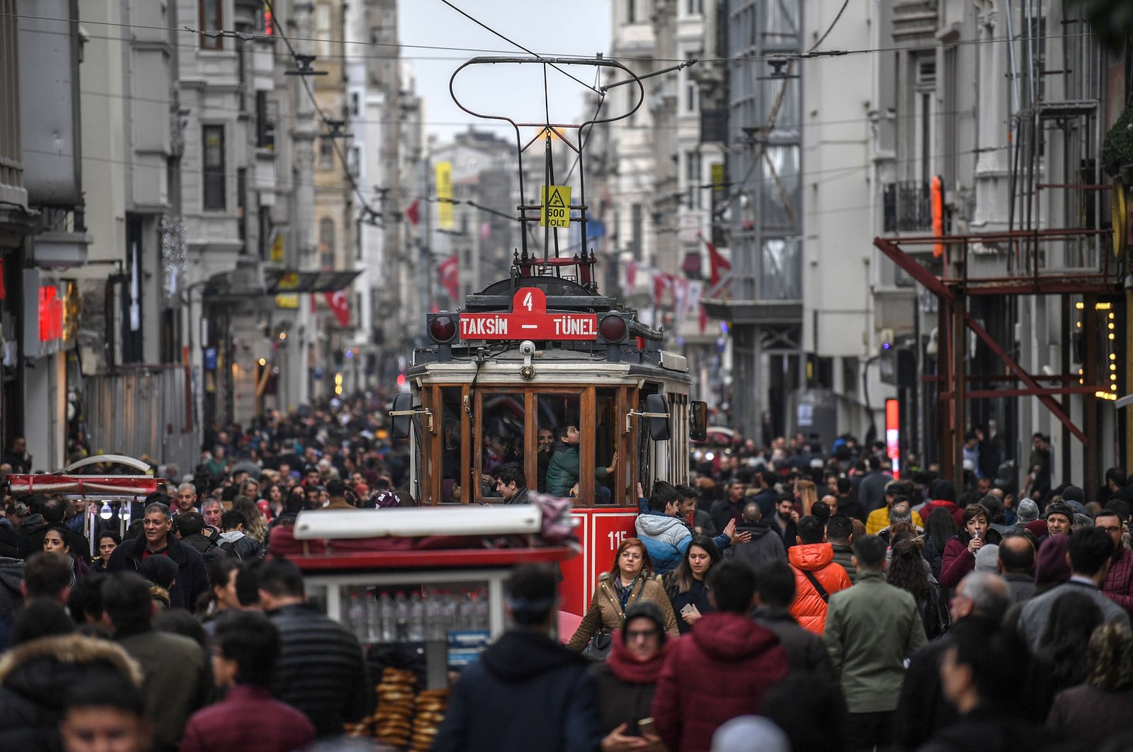 A nostalgic tram drives through a crowd in İstiklal Avenue in Taksim, Istanbul, Jan. 25, 2019. (AFP Photo) 