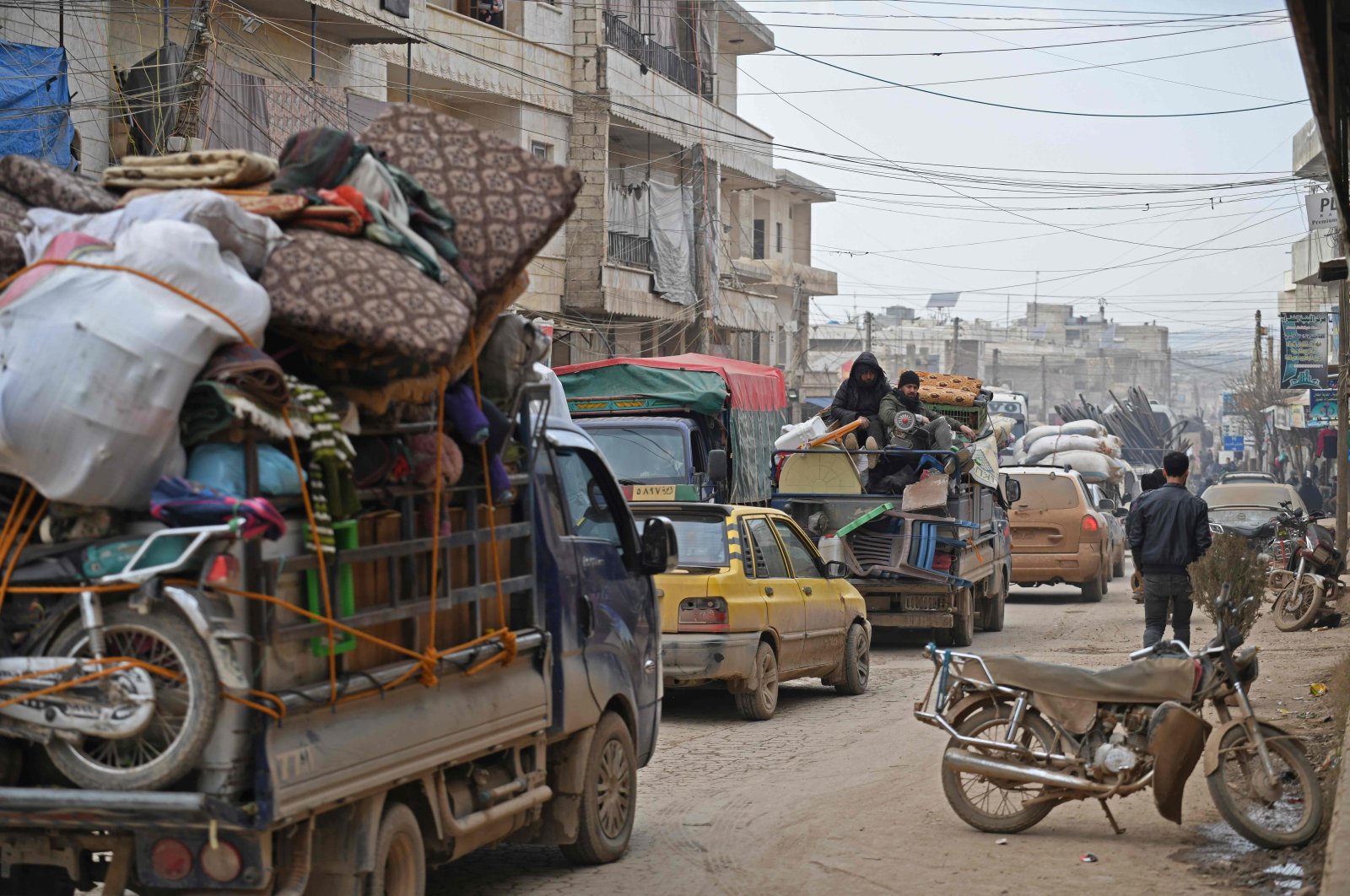  Vehicles carrying internally-displaced persons (IDPs) and their belongings drive through the Syrian town of Atme near the Turkish border towards the city of Afrin, as people flee advancing Syrian regime forces in Idlib and Aleppo provinces, Feb. 17, 2020. (AFP)