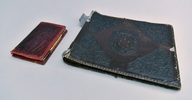 The photo album is pictured with a notebook. (Courtesy of Auschwitz Memorial Museum)