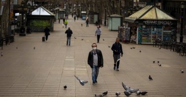 People walk along La Ramblas in Barcelona, Spain, March 15, 2020. (AP Photo)