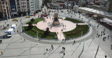 People walk at Taksim Square, Monday, March 16, 2020, Istanbul. The square was one of the busiest places in the city before the virus scare emerged. (DHA Photo) 