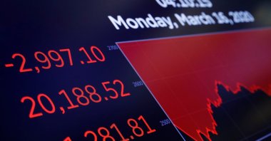 A price screen display is seen above the floor of the New York Stock Exchange (NYSE) shortly as coronavirus disease (COVID-19) cases in the city of New York rise, in New York, U.S., March 16, 2020. (Reuters Photo)