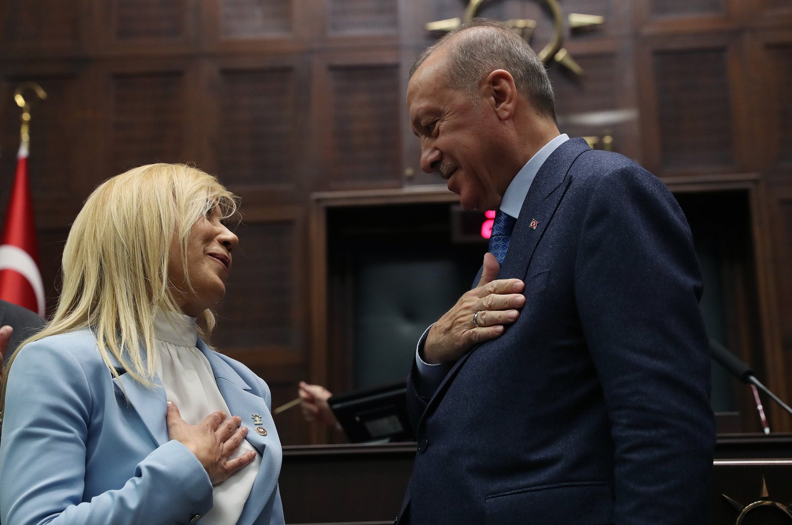 President Recep Tayyip Erdoğan salutes Antalya Deputy Tuba Vural Çokal after she joined the AK Party's ranks during a ceremony in the party's parliamentary group meeting, Ankara, Thursday, March 12, 2020. (AA)