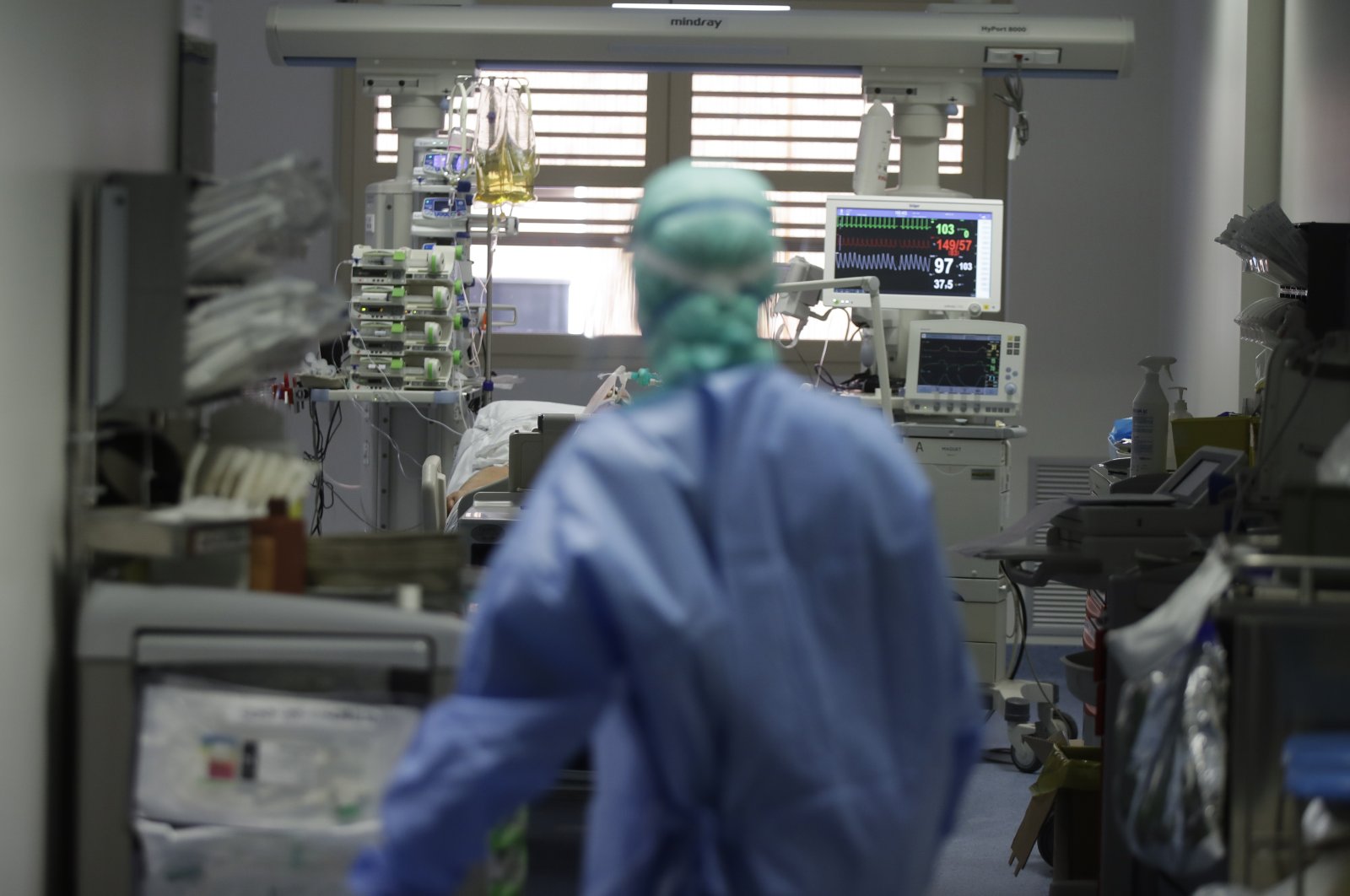 A doctor watches a coronavirus patient under treatment in the intensive care unit of the Brescia hospital, Italy, Monday, March 16, 2020. (AP Photo)