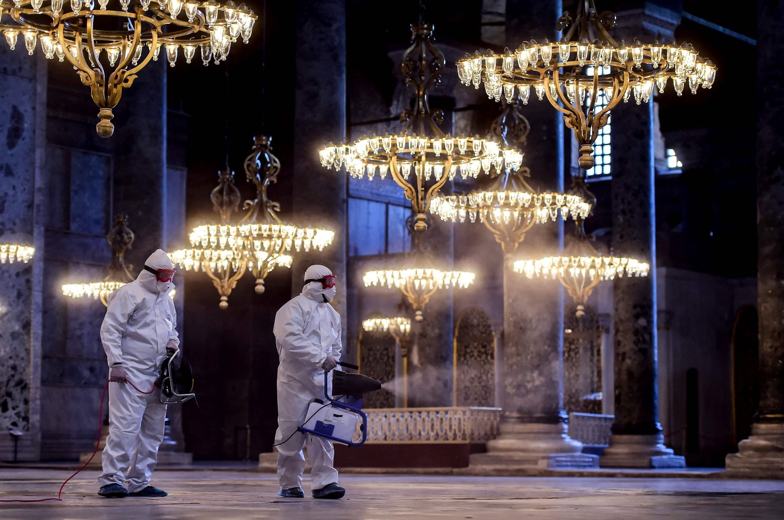 Employees of the Fatih Municipality wearing protective suits disinfect the Hagia Sophia to prevent the spread of the COVID-19, Istanbul, March 13, 2020. (AFP Photo)