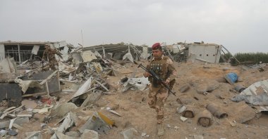 Iraqi army soldiers inspect the destruction at an airport complex under construction in Karbala, Friday, March 13, 2020. (AP Photo)