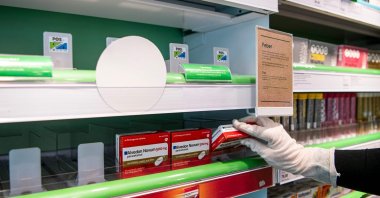 A pharmacy worker stocks boxes of Paracetamol amid the outbreak of COVID-19, Sundbyberg, Monday, March 16, 2020. (AFP Photo)