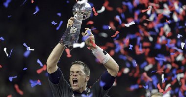 In this file photo, New England Patriots' Tom Brady raises the Vince Lombardi Trophy after defeating the Atlanta Falcons in overtime at the NFL Super Bowl 51 football game in Houston, Texas, Feb. 5, 2017. (AP Photo)