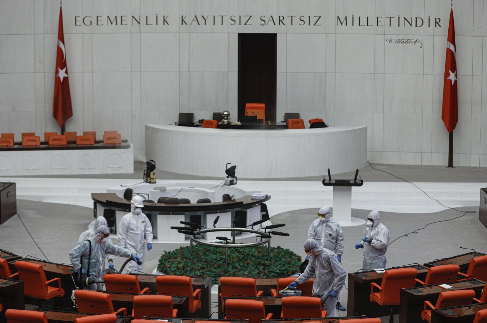 Workers disinfect the General Assembly at the Grand National Assembly of Turkey on Tuesday, March 17, 2020. (DHA Photo)