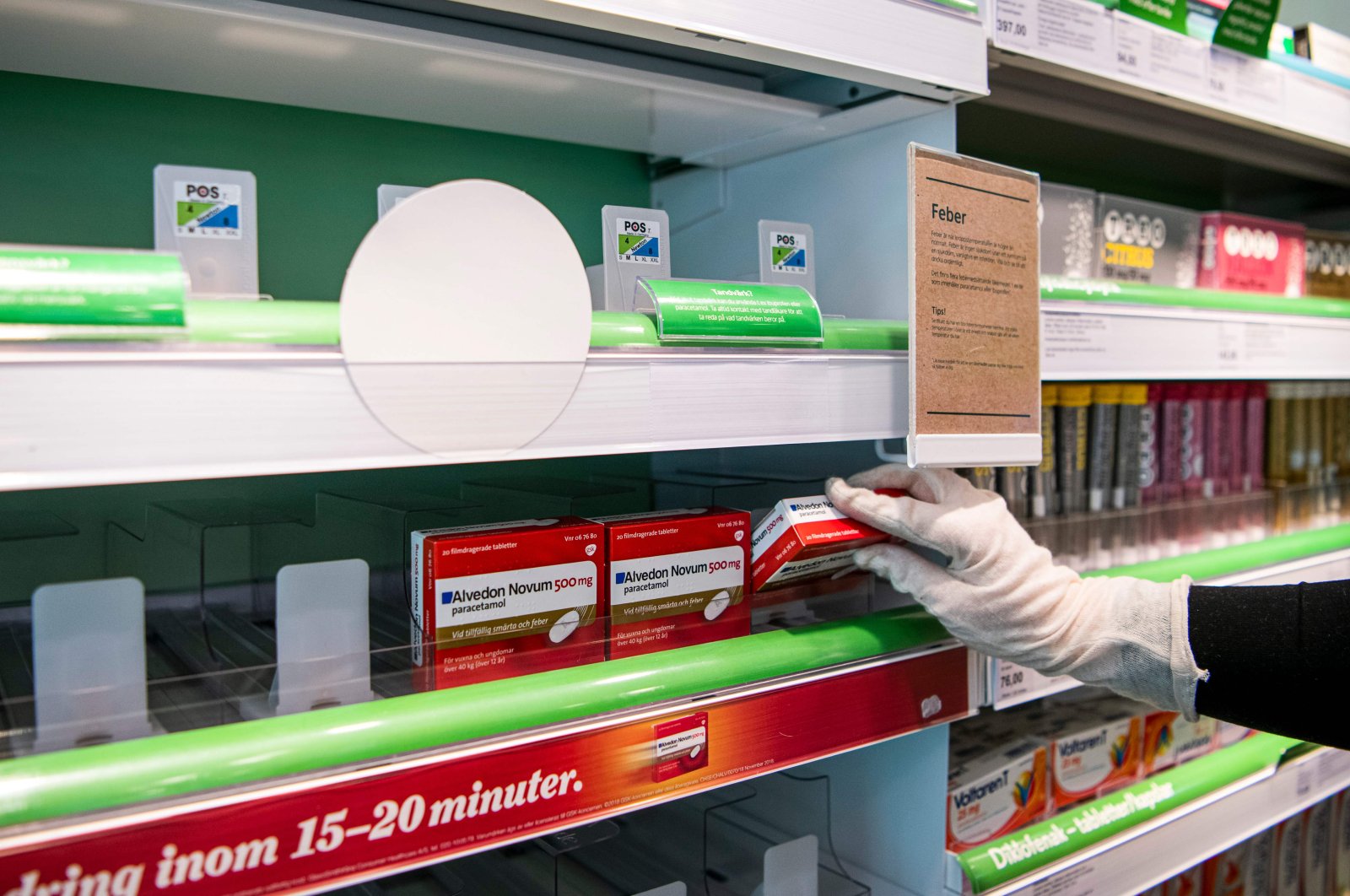 A pharmacy worker stocks boxes of Paracetamol amid the outbreak of COVID-19, Sundbyberg, Monday, March 16, 2020. (AFP Photo)