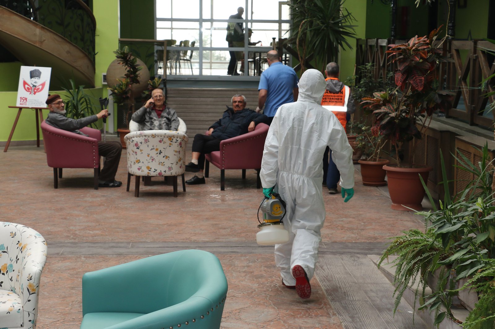 A health worker in protective suit walks around in a nursing home in Samsun, March 16, 2020. (DHA Photo)
