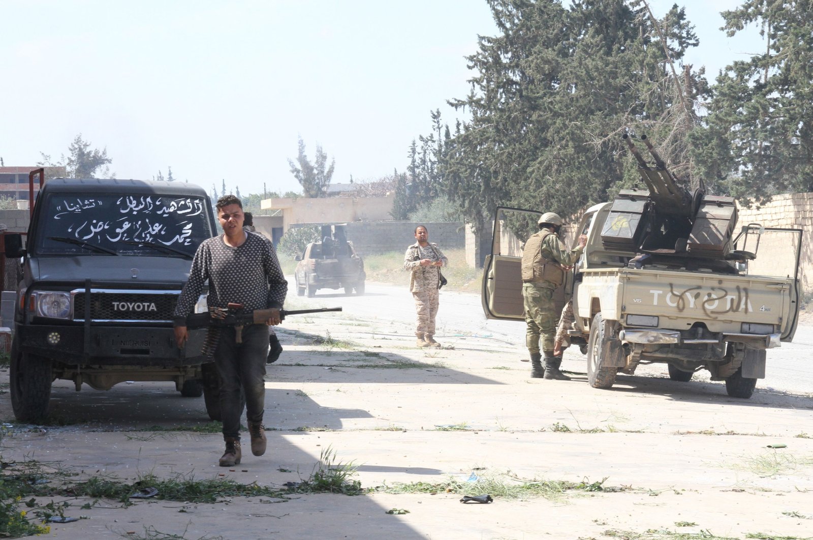 Fighters loyal to the internationally recognised Libyan Government of National Accord (GNA) gather in an area south of the Libyan capital Tripoli, Sunday, March 15, 2020. (AFP)