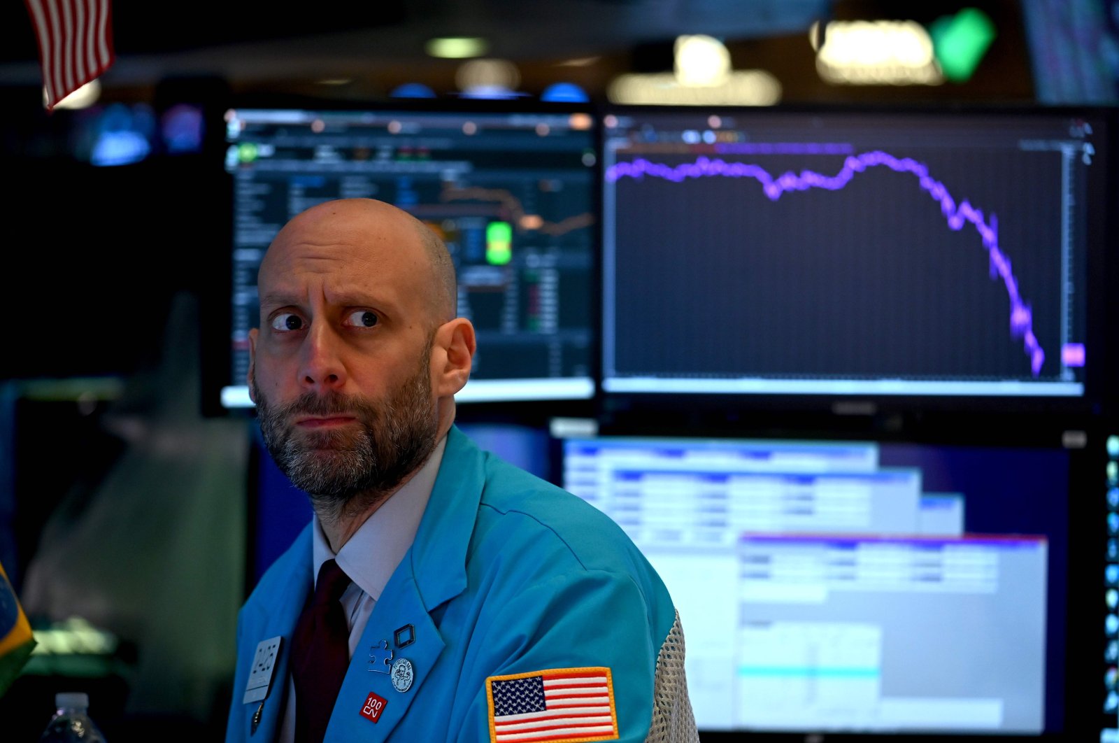 A trader works during the closing bell at the New York Stock Exchange at Wall Street, New York City, Tuesday, March 17, 2020. (AFP Photo)