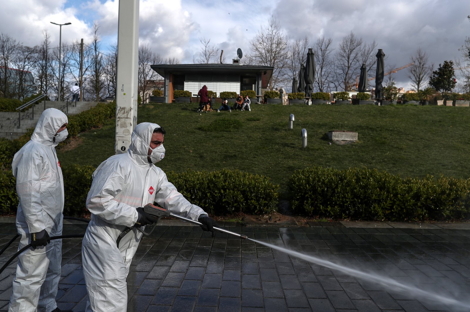 Employees of the Istanbul Metropolitan Municipality disinfects near Gezi Park to prevent the spread of the novel coronavirus COVID-19 at the Taksim Square in Istanbul, Turkey, 18 March 2020. (EPA Photo)