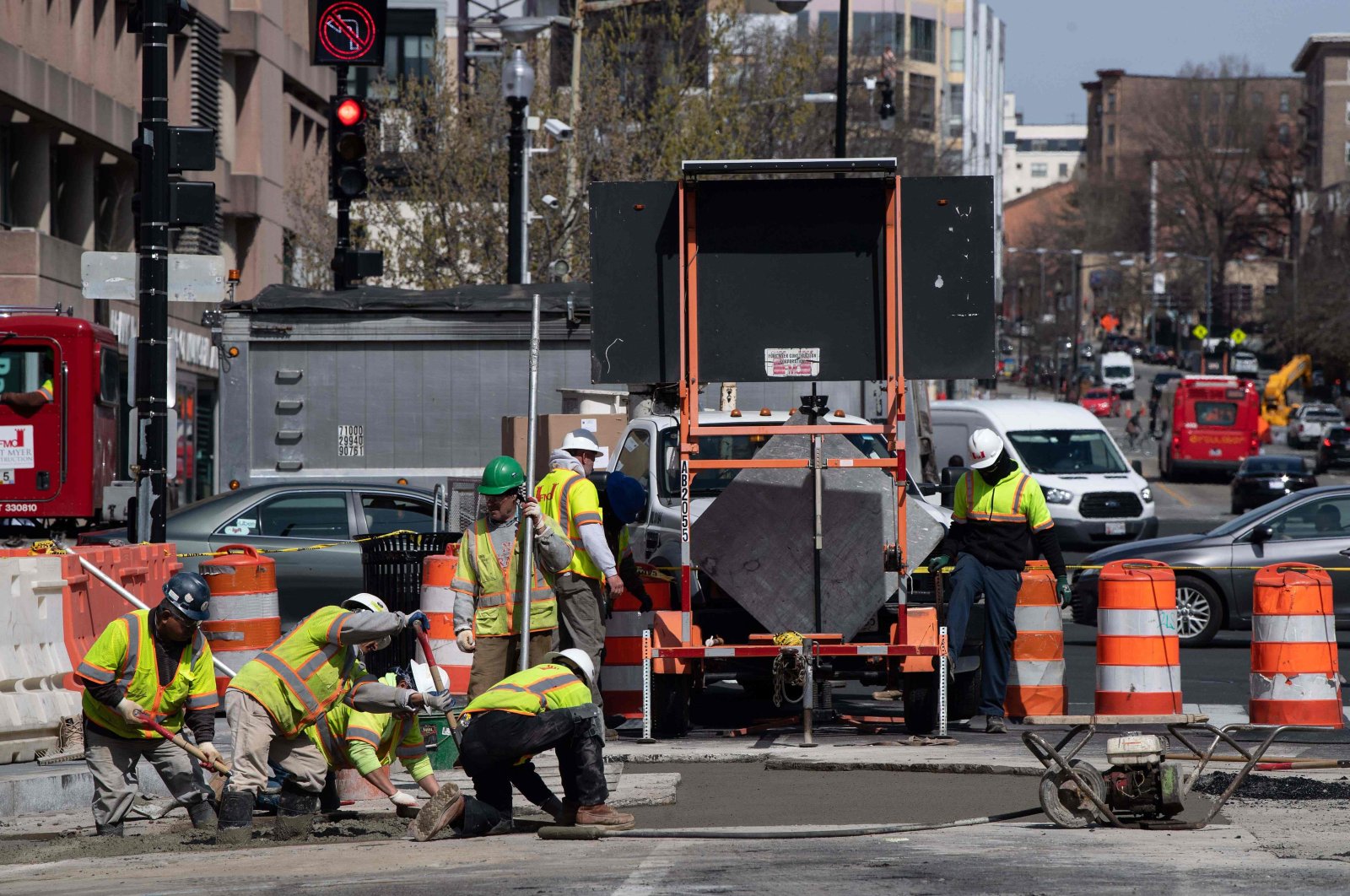 Workers repave a street in Washington, DC, on March 18, as the country deal with the novel coronavirus, COVID-19. (AFP Photo)