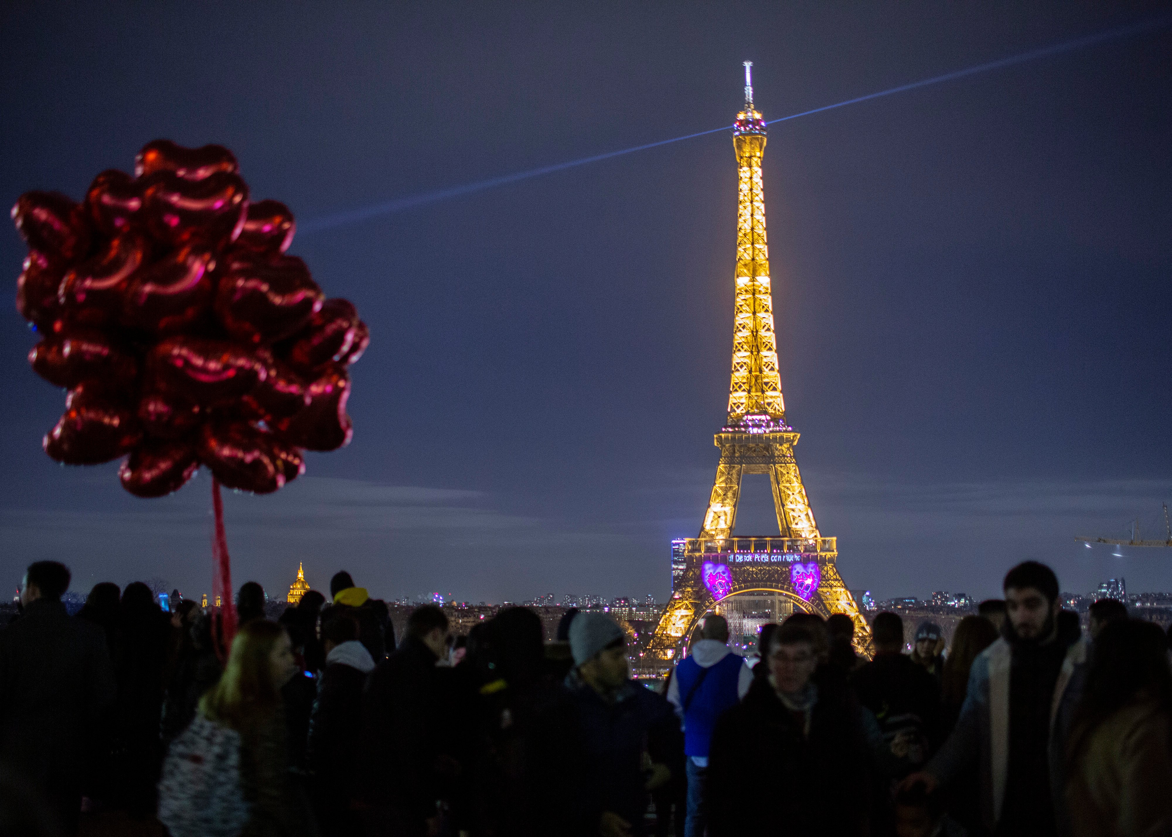 A light show illuminates the Eiffel Tower to mark Valentine