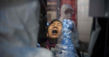 A woman receives a COVID-19 novel coronavirus test swab at a testing booth outside the Yangji hospital in Seoul, South Korea, March 17, 2020. (AFP Photo)