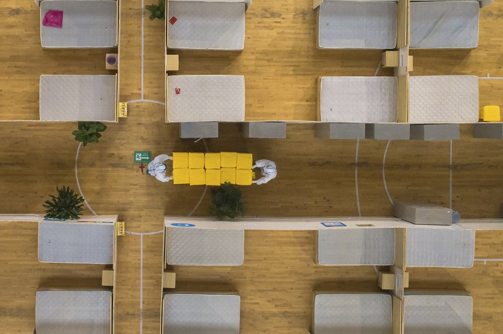 In this March 8, 2020, photo released by Xinhua News Agency, an aerial view shows staff members clean up an empty makeshift hospital in Wuhan, central China's Hubei Province. (Xinhua via AP)