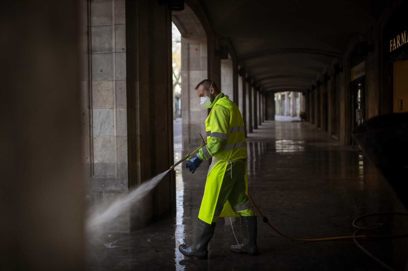 A worker disinfects the street to prevent the spread of the coronavirus in Barcelona, Spain, Thursday, March 19, 2020. (AP Photo)