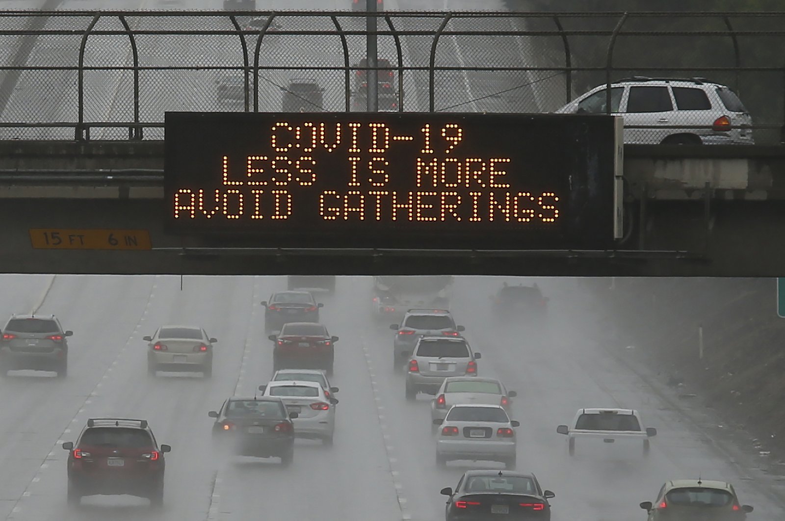 Vehicles pass a COVID-19 warning sign on westbound Highway 50 in Sacramento, Calif., Saturday, March 14, 2020. The California Department of Transportation is displaying public health messages concerning the coronavirus on the state's more than 700 electric signs. (AP Photo)