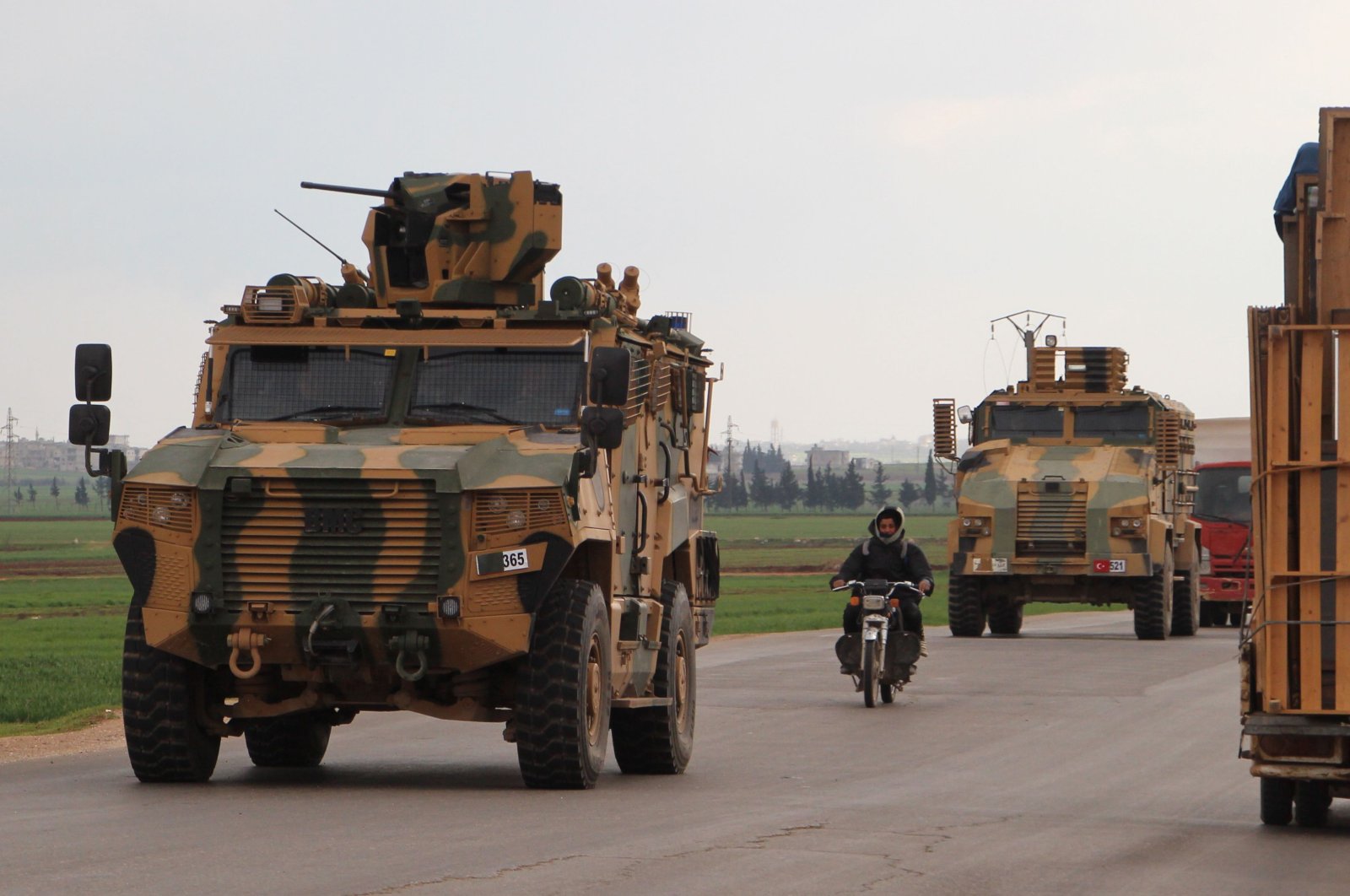 A Turkish military convoy drives on the highway between Bab al-Hawa, crossing on the border with Turkey and the opposition-held town of Ariha, in the northwestern Syrian province of Idlib on March 17, 2020. (AFP Photo)