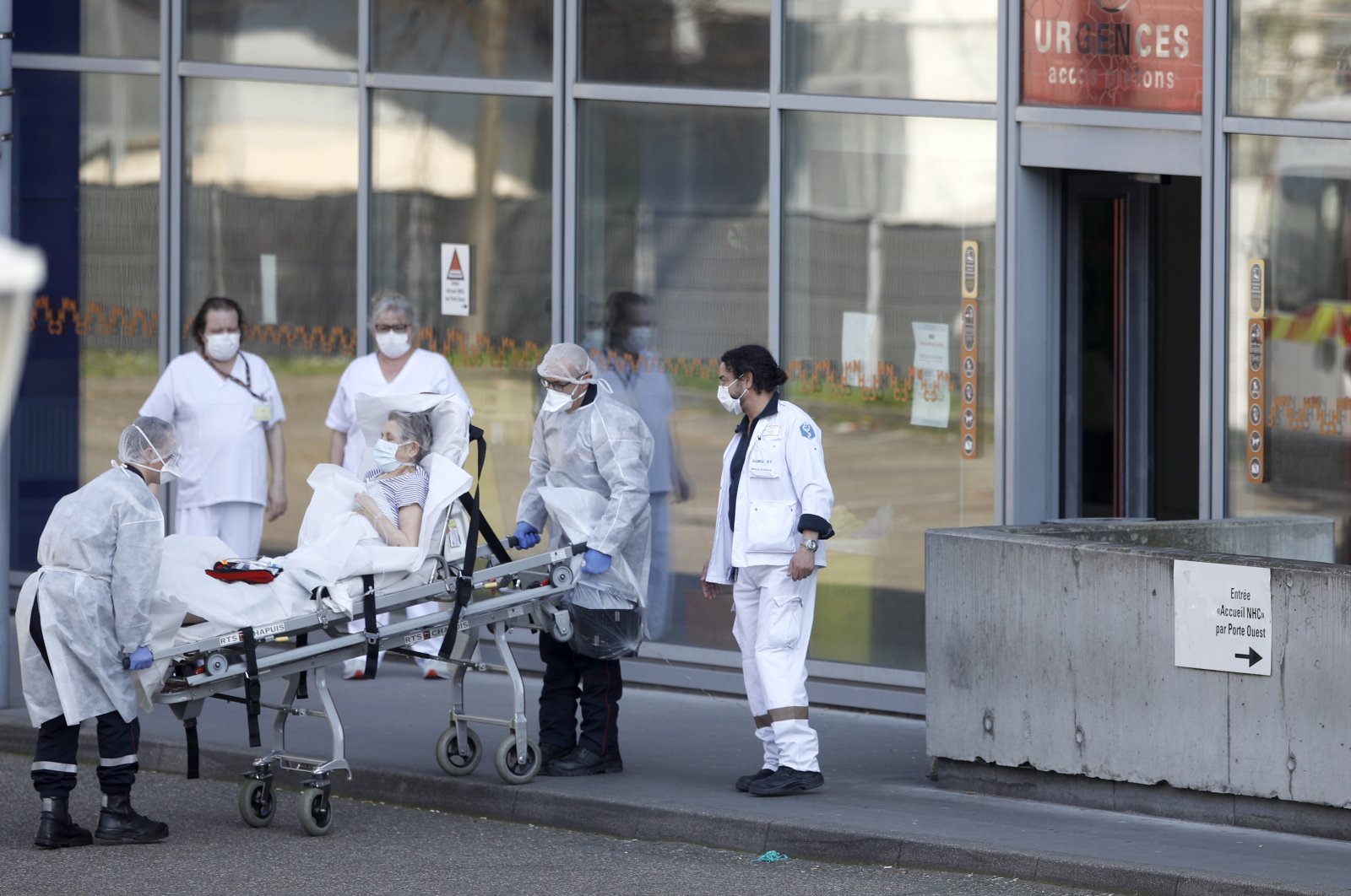 An elderly woman is admitted at the emergency service of an hospital in Strasbourg, eastern France, Thursday, March 19, 2020. (AP Photo)