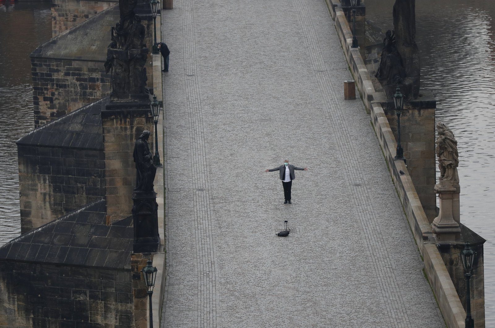 A man takes a selfie on the nearly empty Charles Bridge in Prague, Czech Republic, Friday, March 20, 2020. (AP Photo)