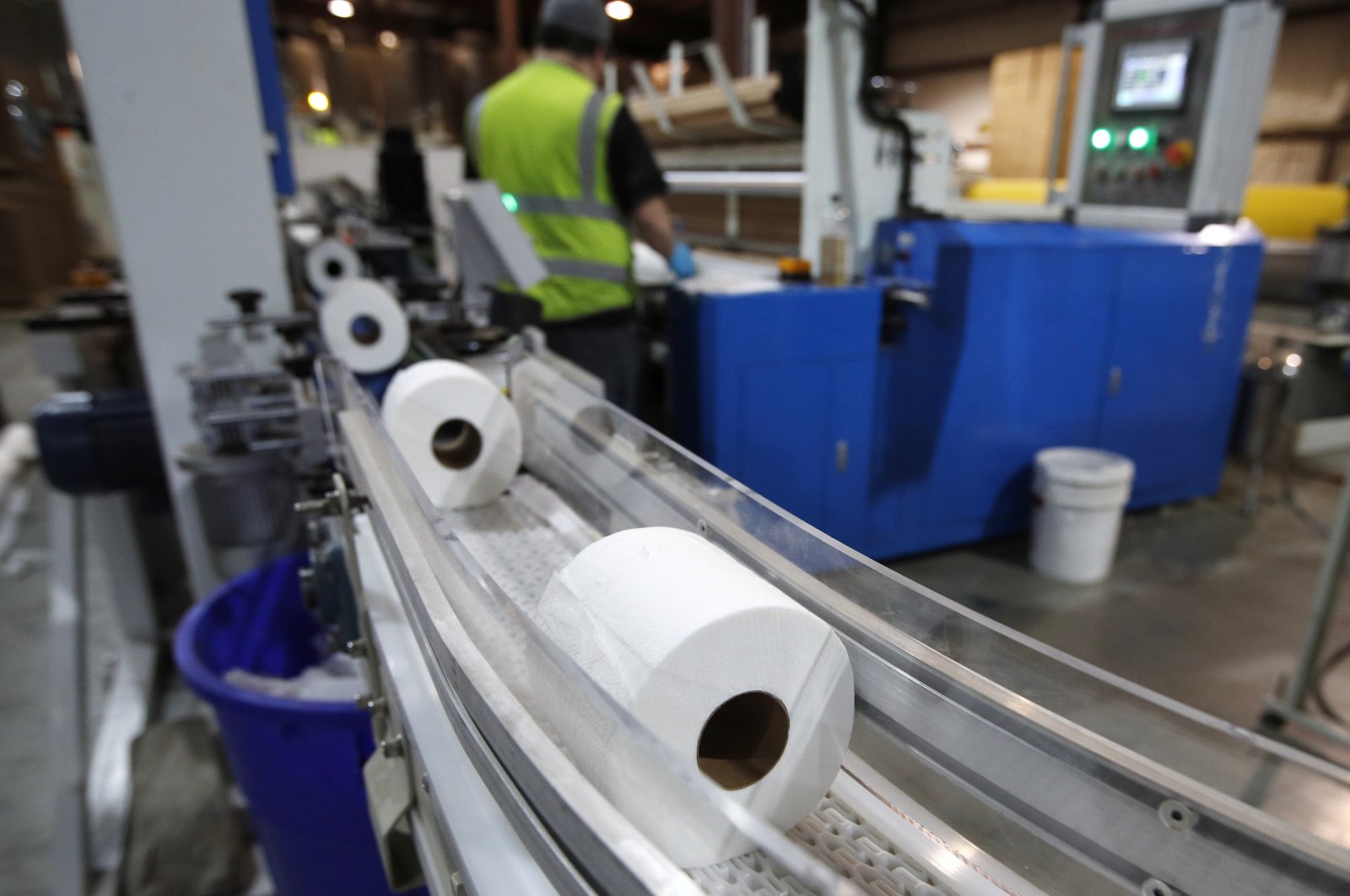 Toilet paper moves out from a cutting machine at the Tissue Plus factory, Wednesday, March 18, 2020, in Bangor, Maine. The new company has been unexpectedly busy because of the shortage of toilet paper brought on by hoarders concerned about the coronavirus. (AP Photo/Robert F. Bukaty)