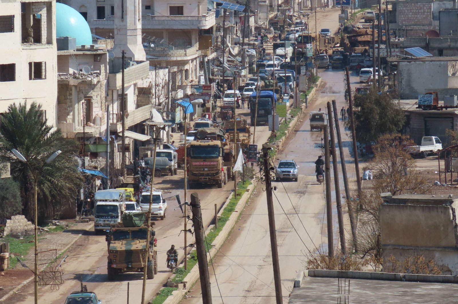 A Turkish military convoy drives through the town of Binnish, in Syria’s northwestern Idlib province near the Turkish border, Thursday, March 19, 2020. (AFP)