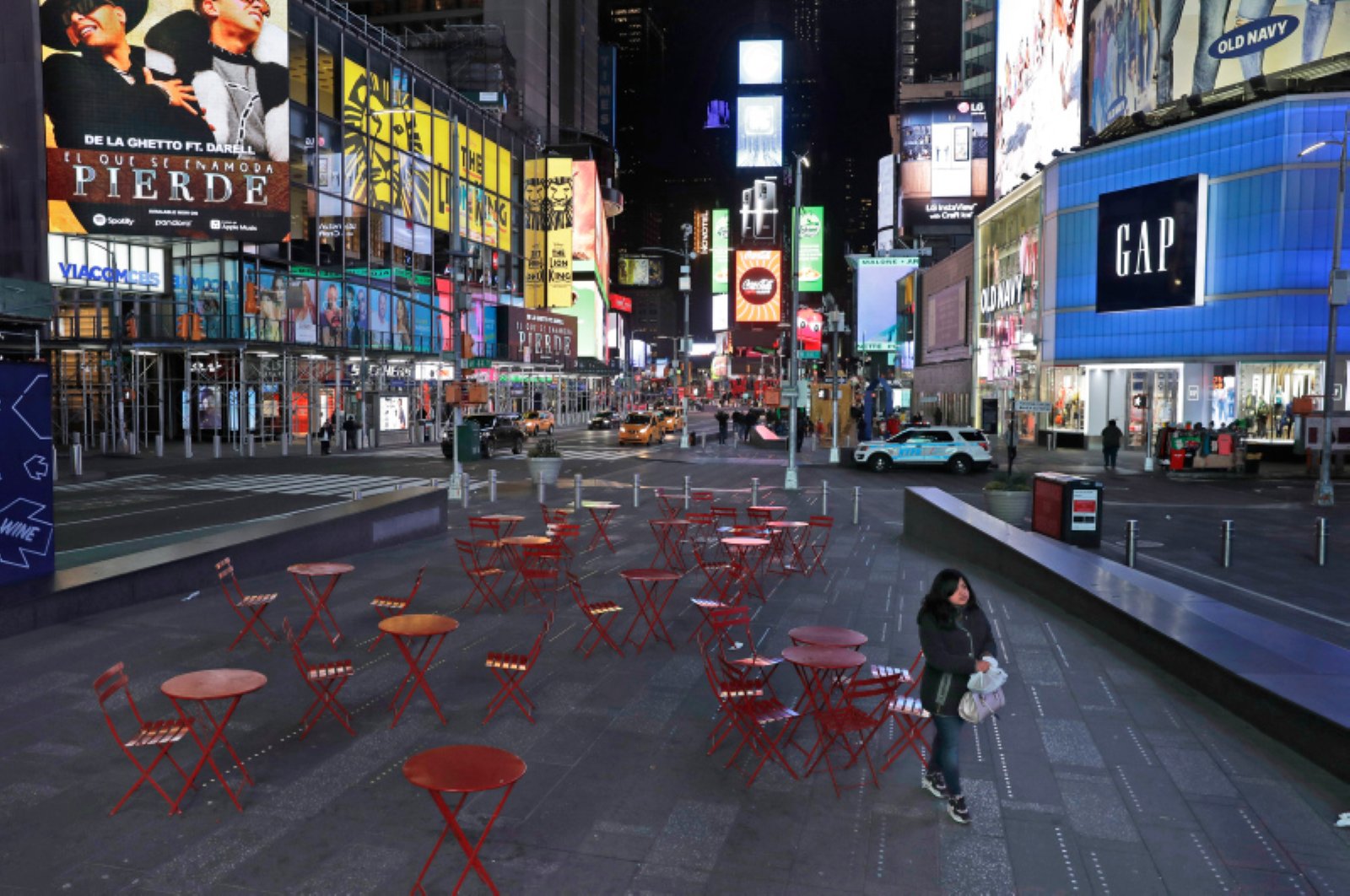 A woman walks through a lightly trafficked Times Square in New York, Monday, March 16, 2020. (AP Photo)
