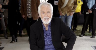 In this Oct. 24, 2017 file photo, Kenny Rogers poses with his star on the Music City Walk of Fame in Nashville, Tenn. (AP Photo)