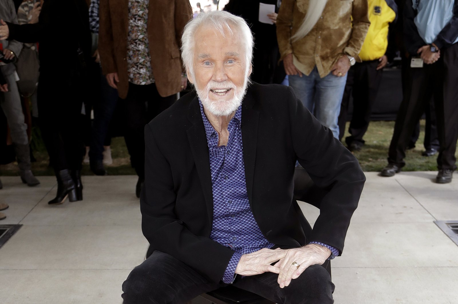 In this Oct. 24, 2017 file photo, Kenny Rogers poses with his star on the Music City Walk of Fame in Nashville, Tenn. (AP Photo)
