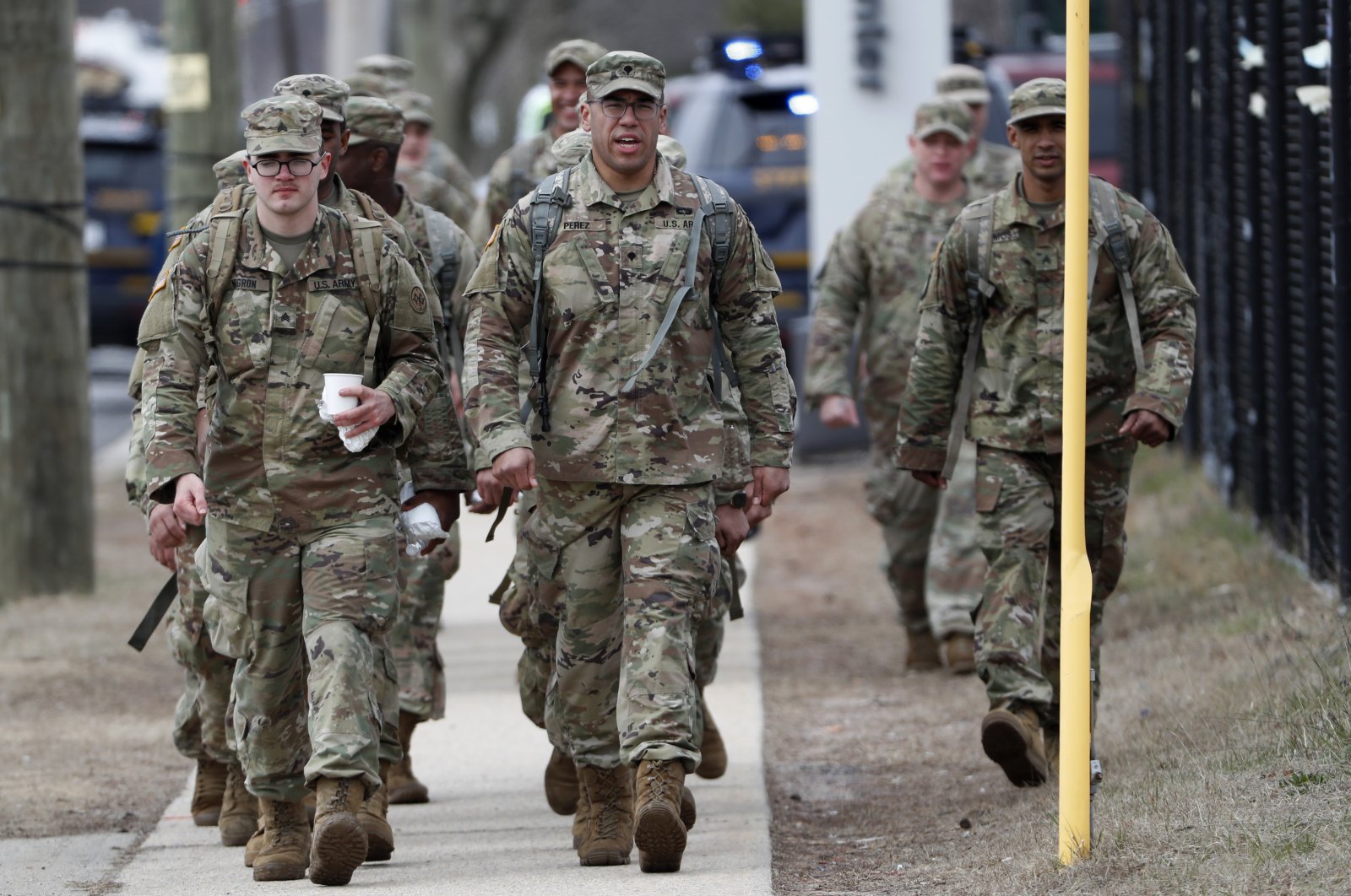 National Guard personnel march in formation as they leave duty after working Thursday, March 19, 2020, at a state-managed coronavirus drive-through testing site that just opened on Staten Island in New York. (AP Photo)