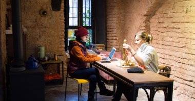 Sculptor Nilhan Sesalan (L) is at her workshop in Kurşunlu Inn with a friend. (AA Photo)