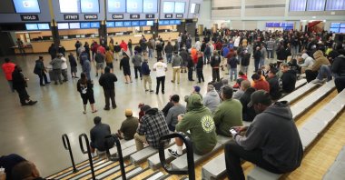 In this file photo taken March 11, 2020, International Longshore and Warehouse Union (ILWU) Local 13 workers await daily job opportunities for Los Angeles and Long Beach ports shortly before sunrise at the ILWU dispatch hall in Wilmington, California. (AFP Photo)