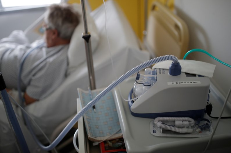 A nasal ventilator sits beside a patient being treated for COVID-19 in a pulmonology unit at a hospital in Vannes, France, March 20, 2020. (Reuters Photo)