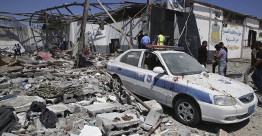 Debris covers the ground and an emergency vehicle after an airstrike at a detention center in Tajoura, east of Tripoli in Libya, July 3, 2019.  (AP)