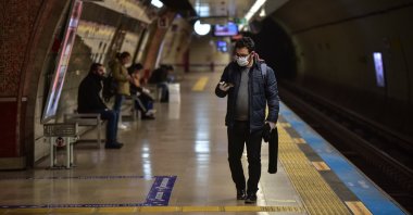 A man wearing a mask walks at a metro station, Monday, March 23, 2020, in Istanbul. (DHA Photo)